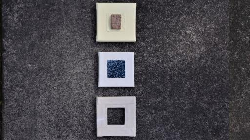 A ceramic artwork of a trio of squares