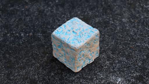 A vibrant turquoise and beige ceramic block