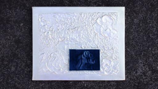 A ceramic artwork of an inky blue rectangle on a textured background