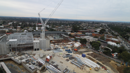 A crane over a construction site including a metal building structure