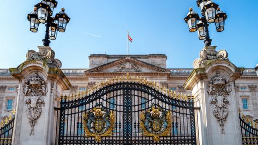 Buckingham Palace, London, with coat of arms and ornate lanterns