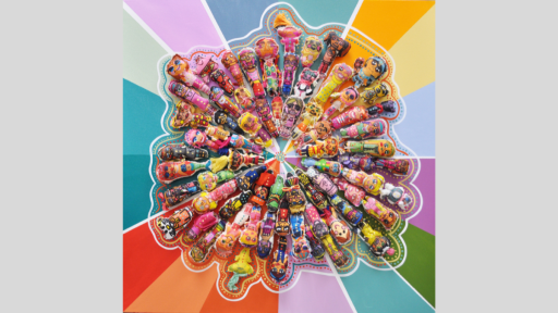 Artwork depicting plush toy dolls lying down in a circular formation, on a paint background of various colour panels.