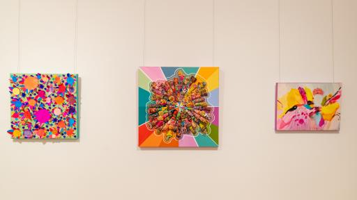 3 colourful paintings on a white wall