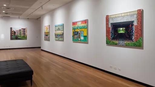 Brightly painted artworks on a gallery wall