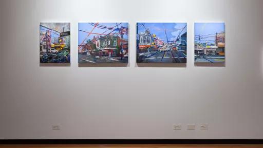paintings of streets bisected by overhead tram lines