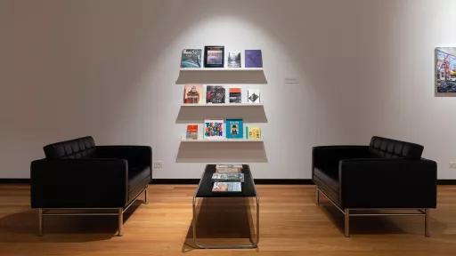 readiing space with couches, coffee table and rack of books