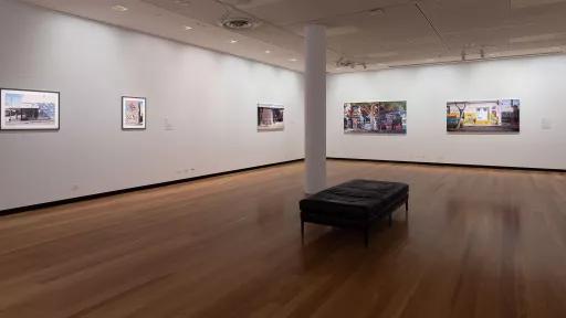 paintings on the wall of an art exhibition