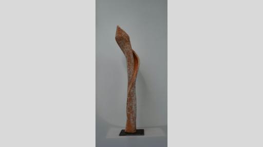 Vertical, cylindrical sculpture reminiscent of an orchid in orange and white