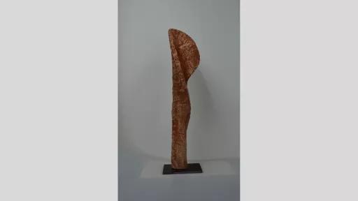 Vertical sculpture like a petal unfurling in red and orange