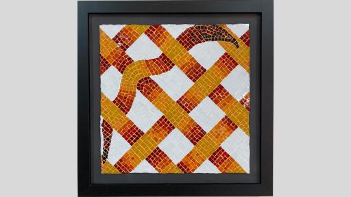 An artwork featuring a mosaic with diagonally thatched strips that are red, orange and yellow, and one diagonal strip is wavy like a snake