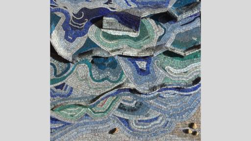 An artwork featuring a mosaic that appears in blues, greens, whites, and navies in a pattern live waves over the area, and 3 rocks in the bottom right corner as well as one in the centre along the base of the artwork