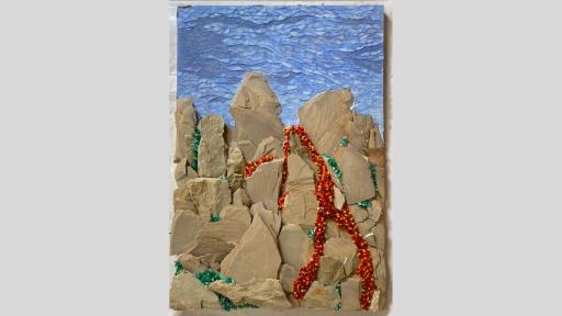 An artwork featuring a mosaic of natural beige stones layered to create a mountain-like image with a blue mosaic sky overhead and red yellow and orange pieces flowing down the mountain in streams like lava