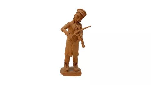 Unpainted, clay sculpture of a man standing and playing a violin. He is wearing a long coat, big, unlaced boots and a cap. His mouth is slightly open, and his head is titled down, supporting the violin as he plays.