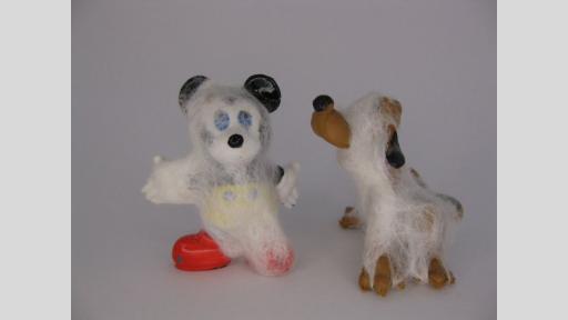 Vintage Mickey Mouse and Pluto the Dog plastic toys are covered in felted wool that looks like thick spider web. This felted wool makes the items appear to have been untouched for years.