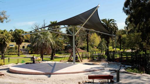 A shaded sandpit area at a park