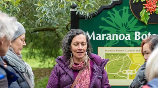 Group of people gathered around Maranoa Gardens signpost