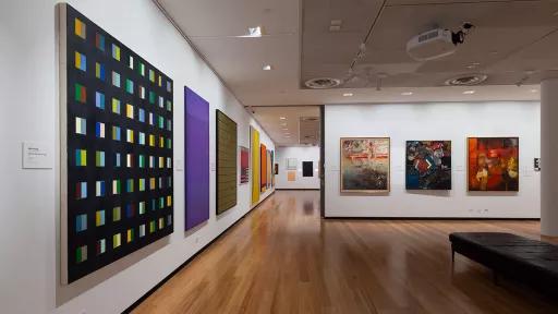 Installation view of abstract paintings hanging in a gallery
