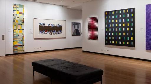 Installation view of abstract paintings hanging in a gallery