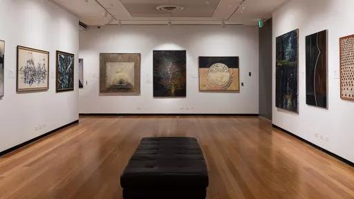 Installation view of abstract paintings hanging in a gallery
