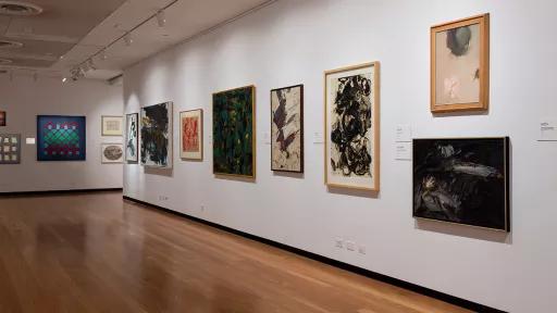 Installation view of abstract paintings hanging in a gallery
