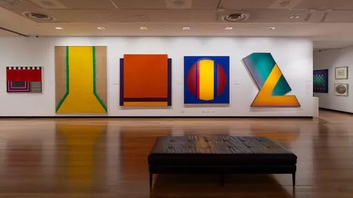 Installation view of abstract paintings hanging in a gallery