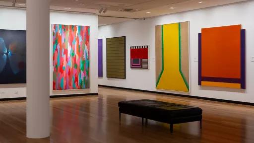 Installation view of abstract paintings hanging in a gallery