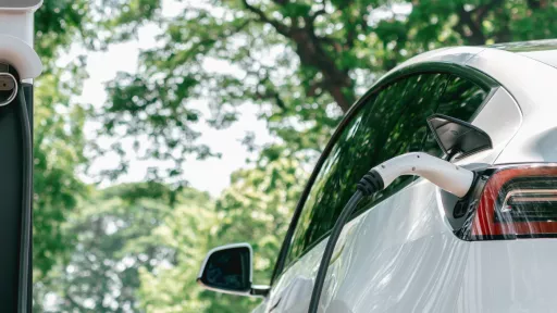 A white electric vehicle is charging