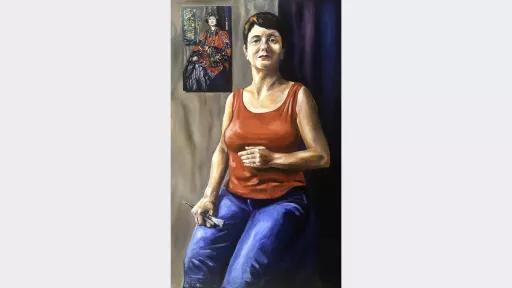 A paintng of a woman holding paint brushes. She sits in a similar position to the woman in a painting that hangs in the background, above her right shoulder.