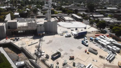 Work site with building materials, structures and vehicles