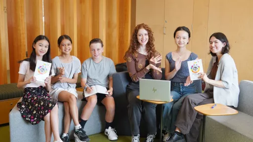 Six Literary Awards winners sit and show off their awards.