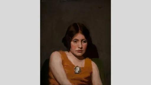 A portrait of a young girl with dark hair and a solemn expression wearing an orange dress and a brooch.