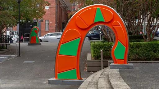 Large, abstract, orange and green public sculpture