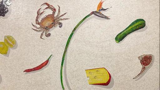 A close up photograph of a mosaic of food items on a white background.