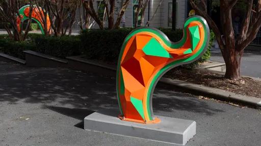 Large, abstract, orange and green public sculpture