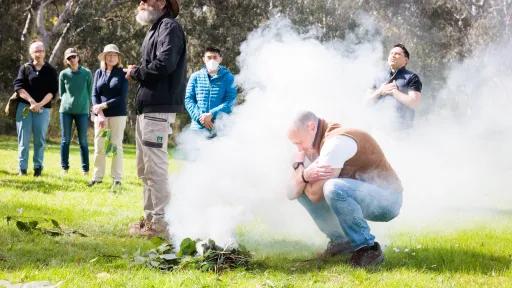 a smoking ceremony in a park on a sunny day