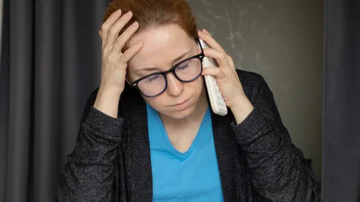 Woman looks distressed while talking on phone