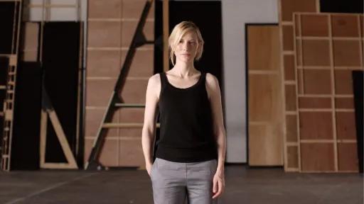 Portrait of actor Cate Blanchett standing front on within a theatre setting
