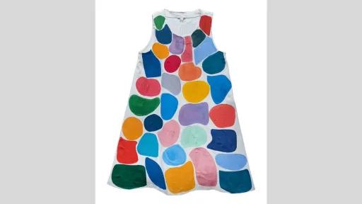 A white sleeveless dress painted with green, blue, red, yellow and purple graphic shapes.