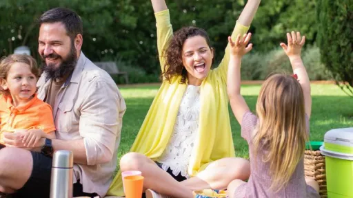 parents and children enjoying a picnic in the park