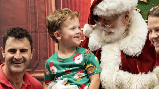 A family sit for a photo with Santa.