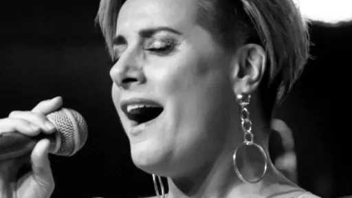 Photo of a woman with a microphone singing