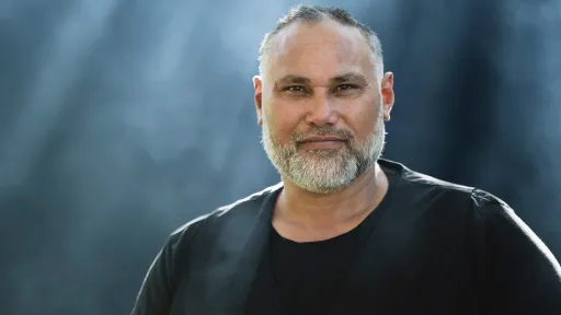 A bearded man against a blurry background