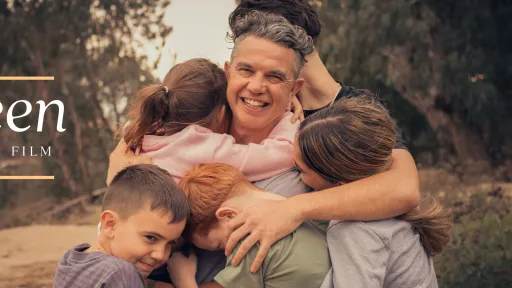 Male embracing his 4 children