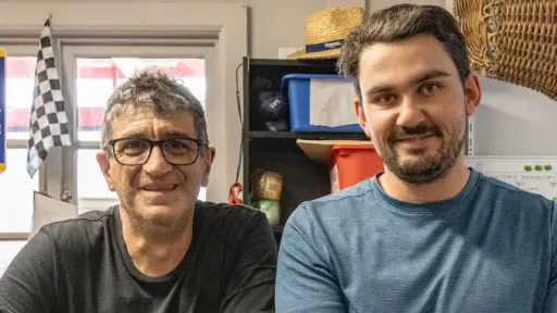 Two men standing at a work bench