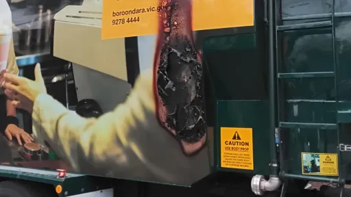 A hole burnt into the side of a recycling truck