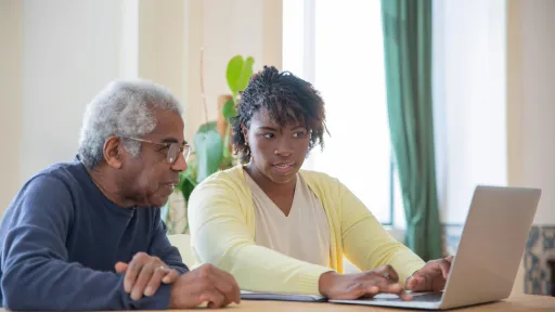 A man and woman using a laptop together