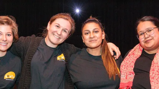 A happy group of young people huddled together