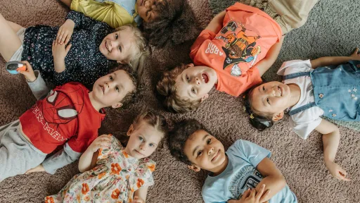 Children lying on the floor in a circle
