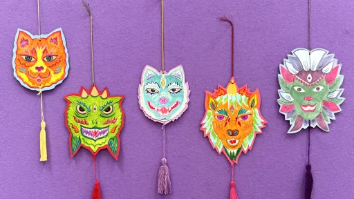 five hanging drawings of animal masks with tassels attached