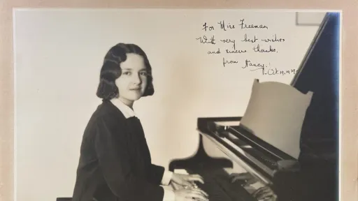 Black and white photograph of a young woman playing the piano